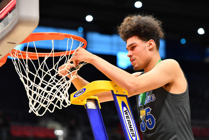 Lutheran East's Jesse McCulloch cuts down the nets after the winning the 2023 OHSAA Division III state championship